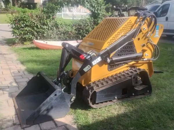 Compact stand-on tracked mini skid steer