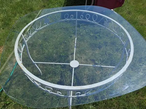 Vintage-style white wrought iron table with glass top