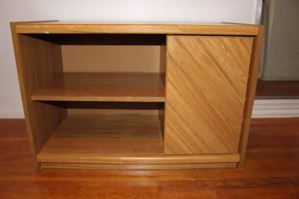 Wooden cabinet with hidden sliding storage shelves