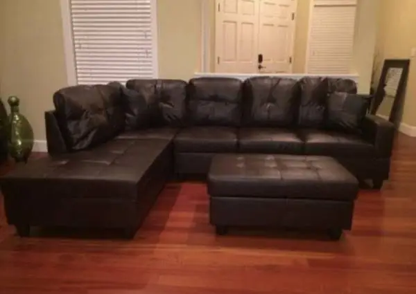 Brown leather sectional couch and  ottoman