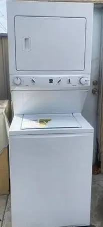 Kenmore like new 27 white stackable washer and gas dryer