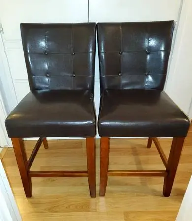 2 Wood and Leather looking counter or bar height chairs, Nice.