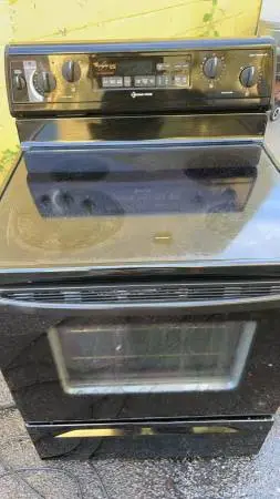 Whirlpool black refrigerator and glass top stove (delivery fee