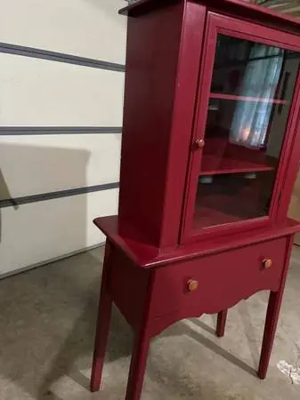 Vintage red painted cupboard with one door and one drawer.