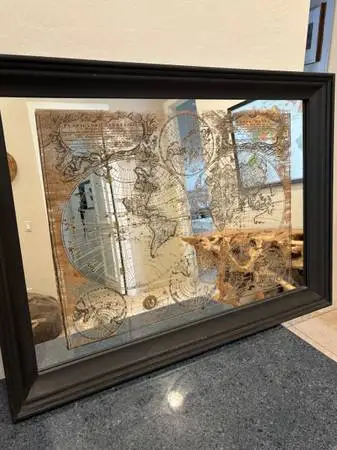 Unique picture of a world map, superimposed on a mirror