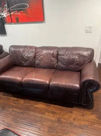 Living room brown real leather sofa has a rip as you can see in the p