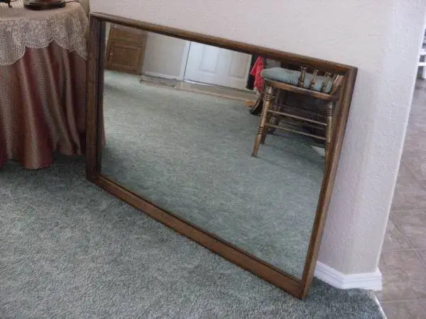 Wooden framed mirror. 25inches high by 40 inches wide.