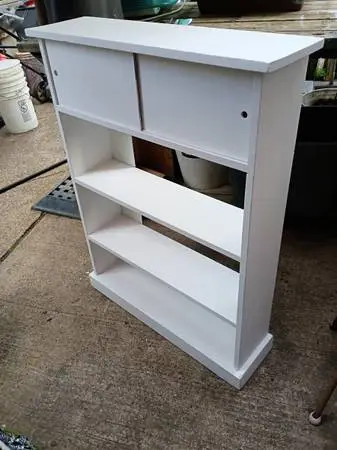 Wooden bookcase with top sliding doors