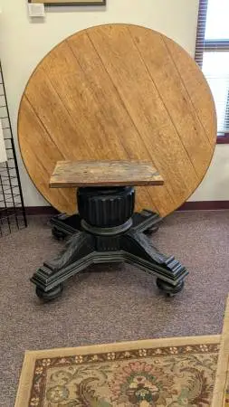 Rustic 5 ft. round white oak table w/ carved wood pedestal base on cas