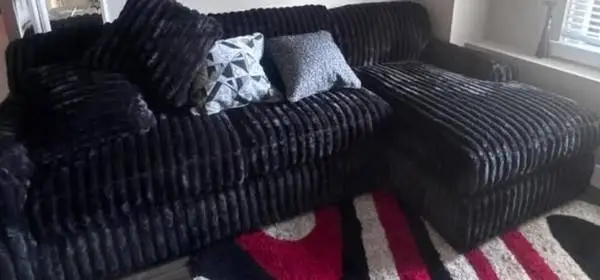 Black small sectional with pillows