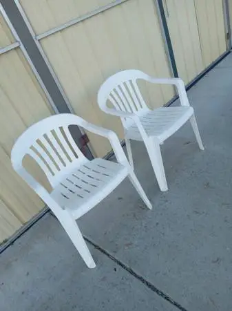 6 white plastic patio chairs $ 10 each , excellent  condition