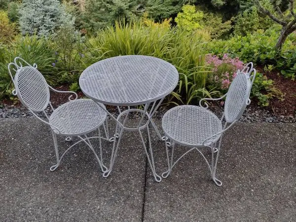 small patio wrought table and 2 chairs