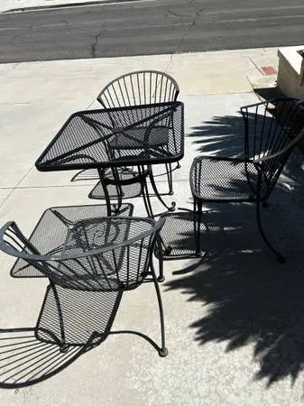 Patio furniture set with black iron mesh table and 3 matching chairs -