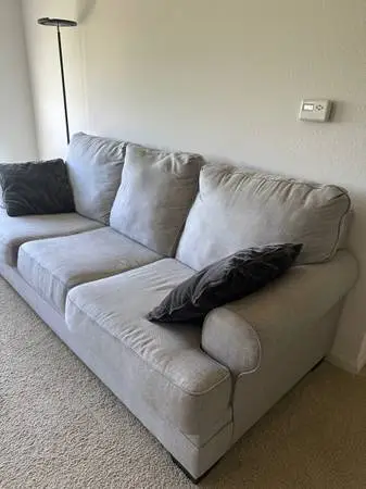 Ashley sofa in a used condition with pillows