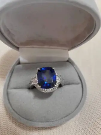 Sterling Silver Ring With Sapphire Color Stone Surrounded By CZs