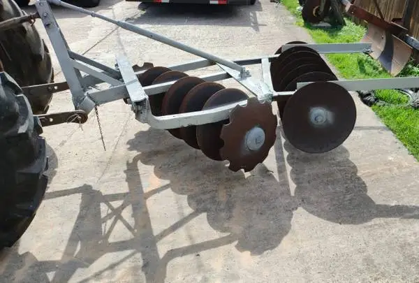 Farm tractor left disk implement