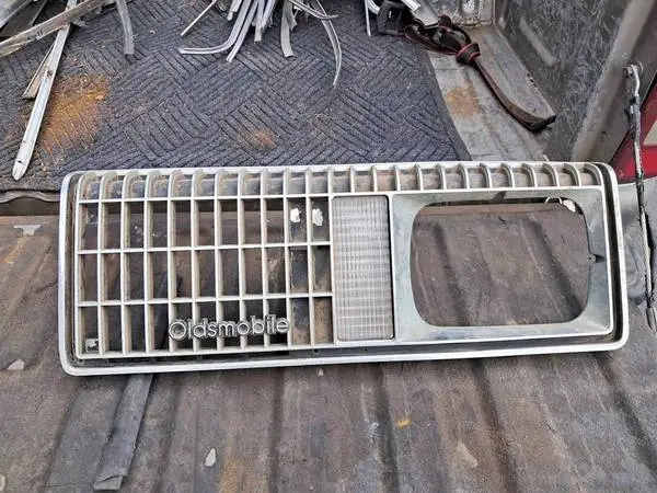81 Oldsmobile Omega LH Headlight Grille Bezel X Body 22506835 LH