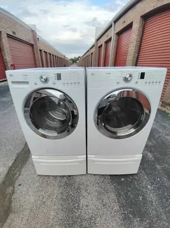 MATCHING LG FRONT LOAD WASHER AND DRYER WITH PEDESTALS.