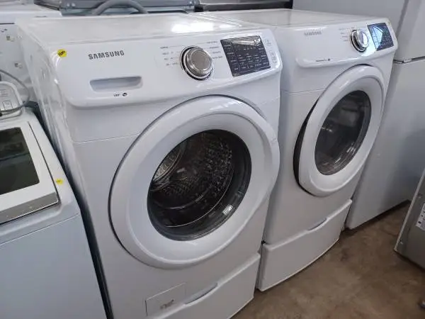 Samsung front load washer and dryer set on pedestals