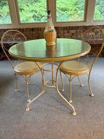 Cafe table with matching chairs cushioned