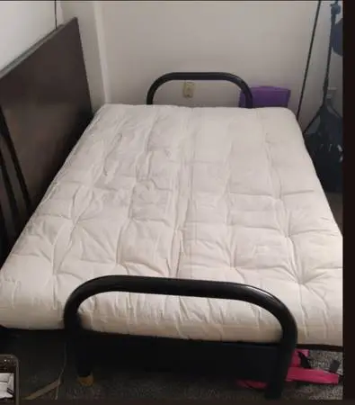 Futon black metal frame and white mattress.