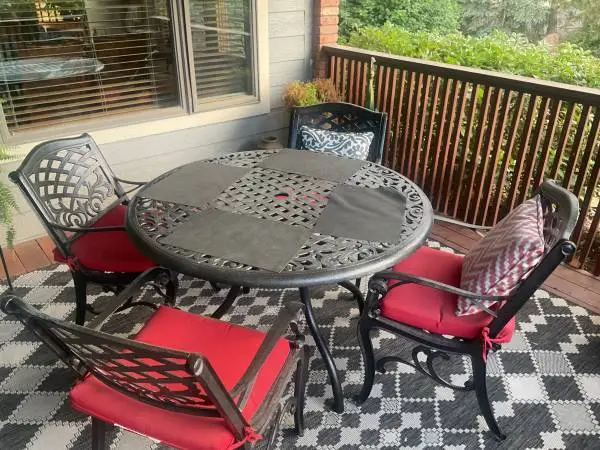 Metal outdoor dining set with chairs and cushions