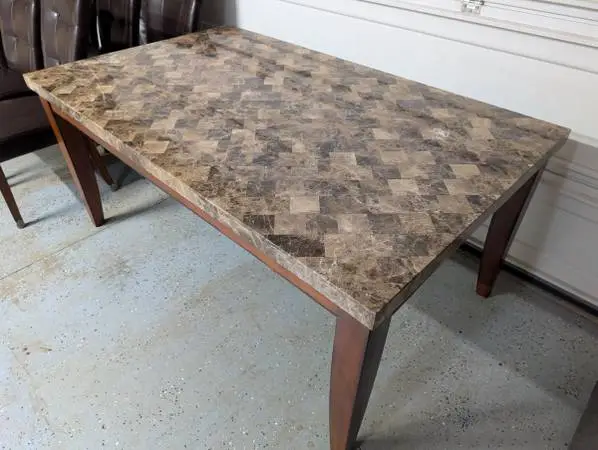 Stone-top dining table with six leather dining chairs