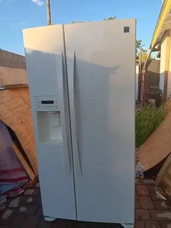Kenmore Elite Refrigerator  side by side  ice and water in door .
